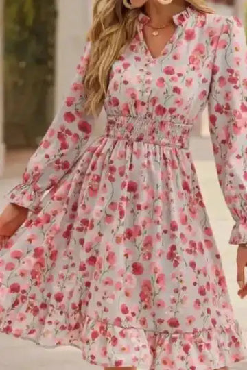 Woman wearing a floral dress with long sleeves in an outdoor setting