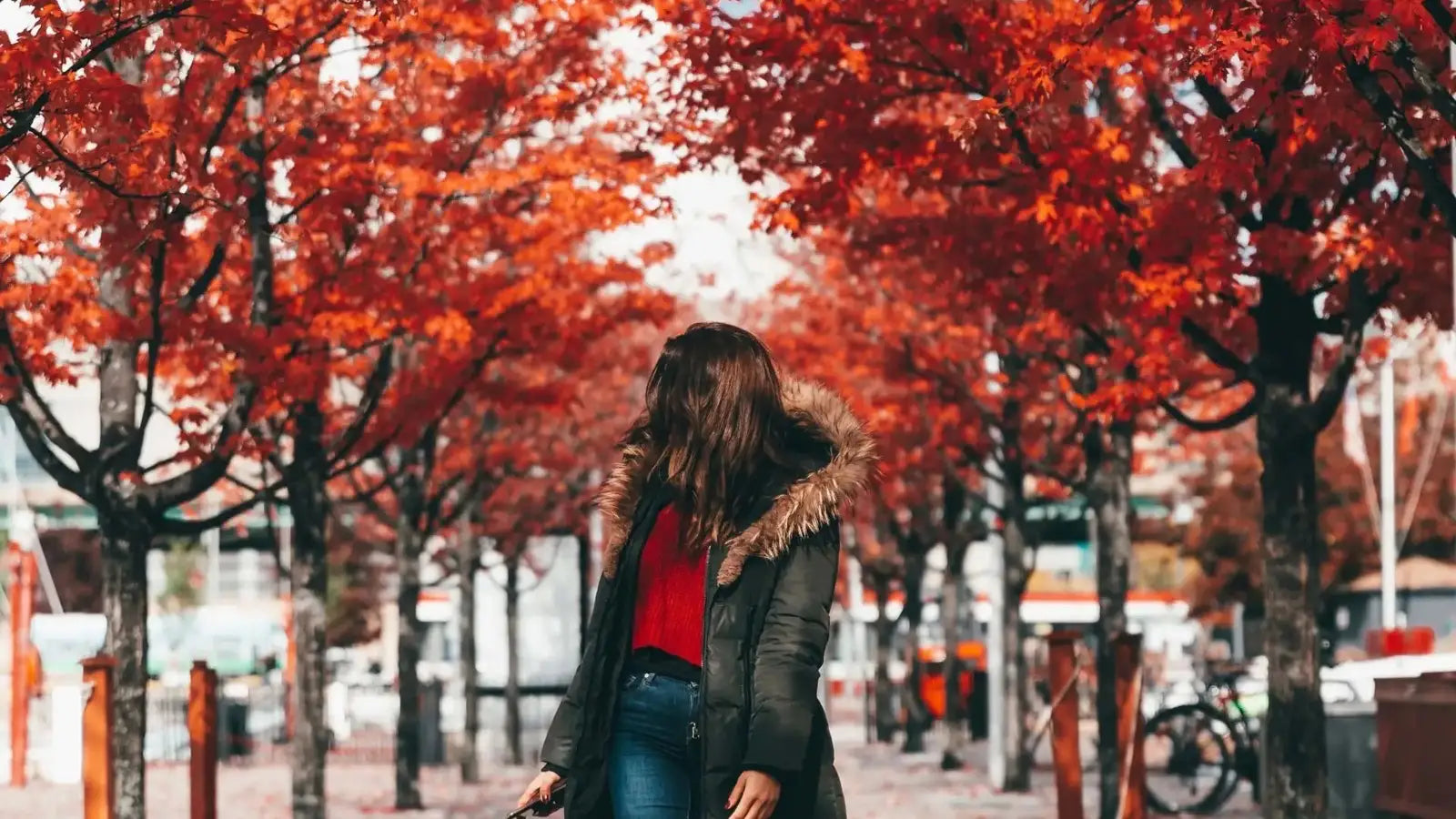 Woman walking through trees