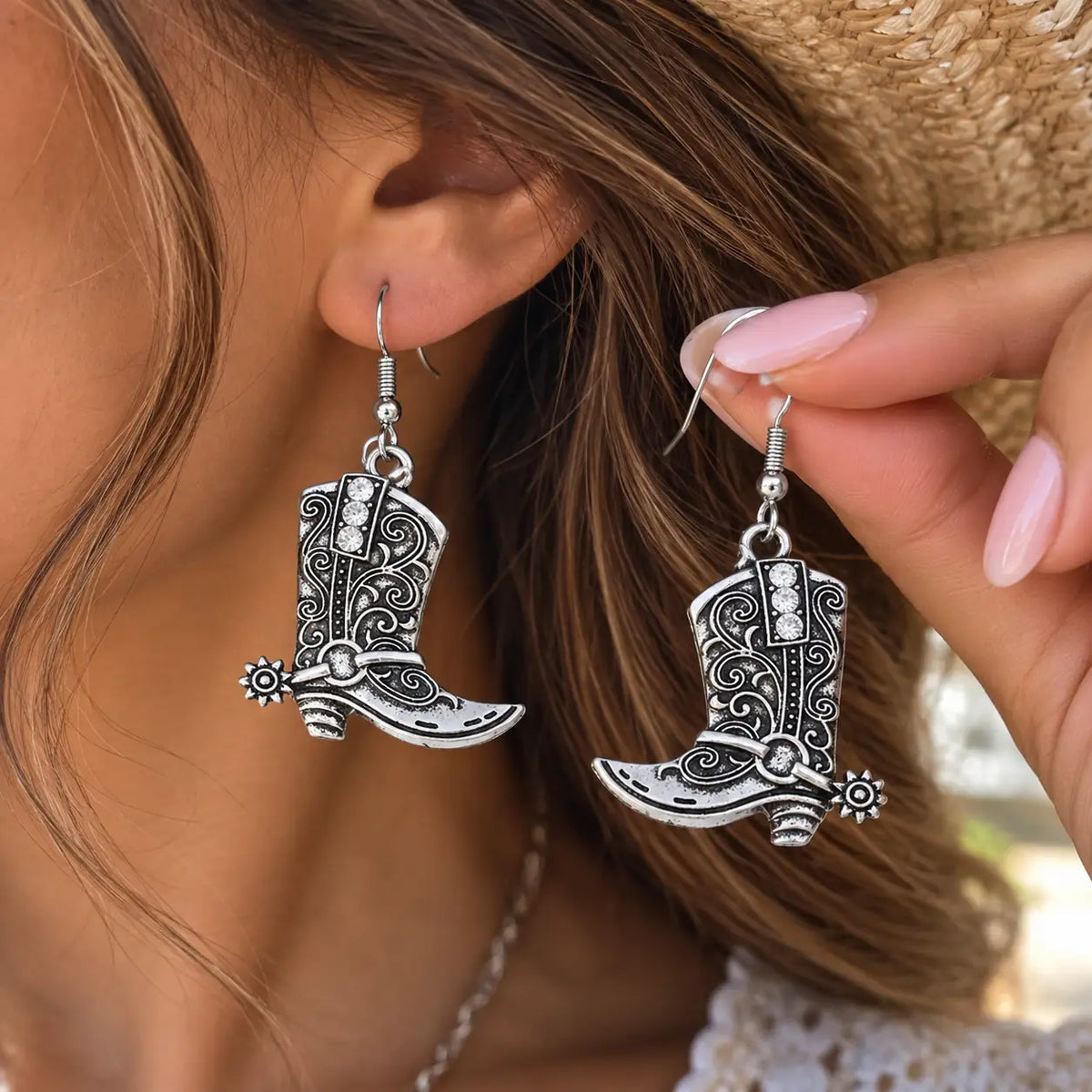 Vintage Western Cowboy Boot Dangle Earrings worn in a western lifestyle setting